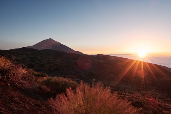Beautiful sunset in nature. View of the volcano Teide in last sunbeams. Tenerife, Canary Islands.